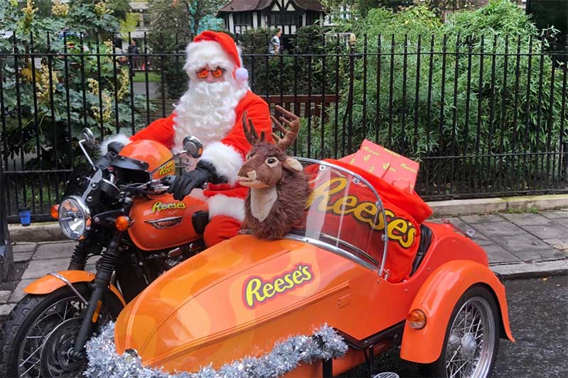 DJ santa riding in a reese's motorbike