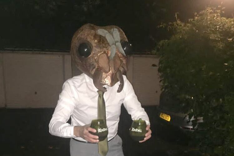 Man dressed as movie monster with cocktails