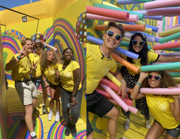 Young 20 somethings working at a festival in a bright yellow inflatable candy crush stall