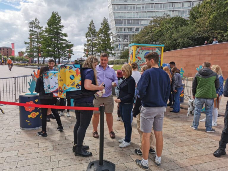 People engaging with street marketeers about tequila