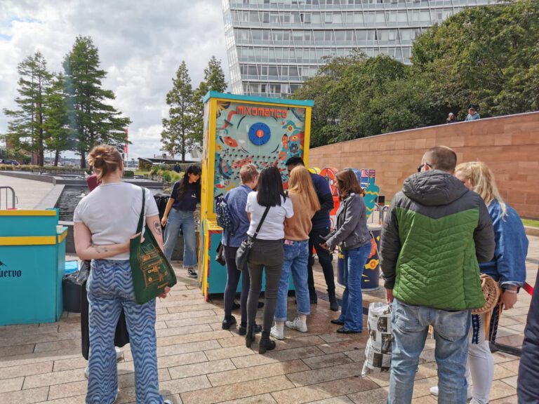 People queuing up for tequila outside with sampling stand